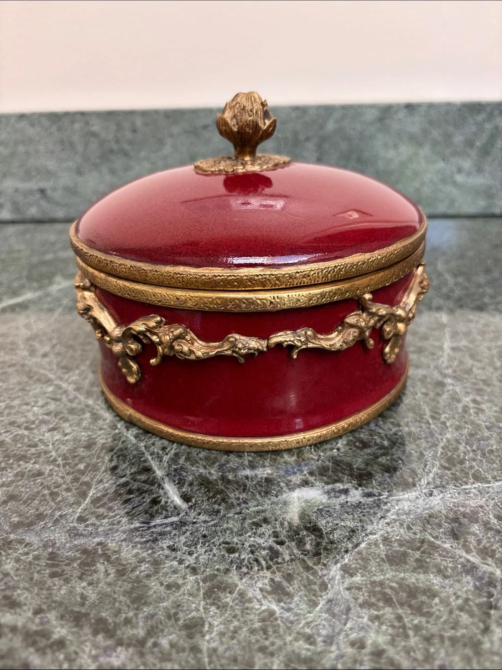 vintage porcelain trinket box with an ornate brass rim
